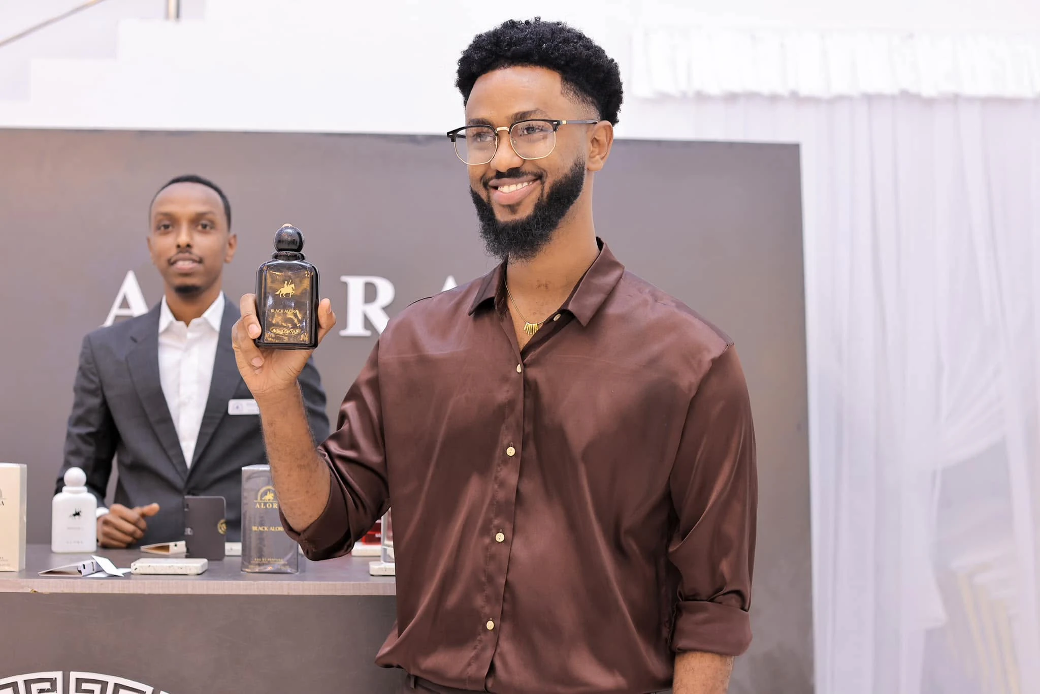 A guest holding a bottle of Black Alora at the ALORA launch
